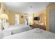 Bright bedroom featuring two beds, a TV, and sunny yellow walls at 210 75Th Ave N # 4032, Myrtle Beach, SC 29572