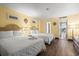 Comfortable bedroom featuring two beds, sunny yellow walls, and wood flooring at 210 75Th Ave N # 4032, Myrtle Beach, SC 29572
