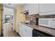 Compact kitchen features appliances, countertop and backsplash and opens to dining area at 210 75Th Ave N # 4032, Myrtle Beach, SC 29572