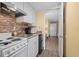 Compact kitchen featuring white appliances and a decorative backsplash at 210 75Th Ave N # 4032, Myrtle Beach, SC 29572