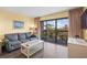 Relaxing living room with a sofa, coffee table, and balcony access at 210 75Th Ave N # 4032, Myrtle Beach, SC 29572