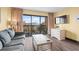 Bright living room with a large tv, sofa, and balcony with a view at 210 75Th Ave N # 4032, Myrtle Beach, SC 29572
