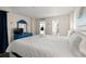 Spacious bedroom with view of kitchen, balcony and large white bed at 210 75Th Ave N # 4033, Myrtle Beach, SC 29572