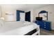 Well-lit bedroom features a blue dresser, mirror and television at 210 75Th Ave N # 4033, Myrtle Beach, SC 29572