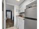 Functional kitchen with white cabinets, essential appliances, and a view into the entryway at 210 75Th Ave N # 4033, Myrtle Beach, SC 29572