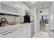 Compact kitchen area featuring white cabinetry and necessary appliances for convenient cooking at 210 75Th Ave N # 4033, Myrtle Beach, SC 29572