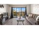 Comfortable living room with a neutral sofa, stylish coffee table, balcony access, and TV, creating a cozy atmosphere at 210 75Th Ave N # 4033, Myrtle Beach, SC 29572