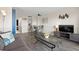 Open living area with a cozy sofa, modern entertainment center, and dining area, creating a warm and inviting space at 210 75Th Ave N # 4033, Myrtle Beach, SC 29572