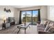 Contemporary living room featuring a comfortable sofa, balcony view, and sleek decor, perfect for relaxing and entertaining at 210 75Th Ave N # 4033, Myrtle Beach, SC 29572