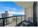 Balcony features chairs and a table with clear ocean views, with other condo buildings off to the left at 2301 S Ocean Blvd. # 825, Myrtle Beach, SC 29577