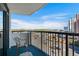 Balcony with seating offers a tranquil view of the city and trees on a sunny day at 2301 S Ocean Blvd. # 825, Myrtle Beach, SC 29577