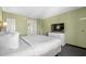 Bright bedroom boasts a cozy king-size bed, modern TV, dresser, and hallway access to other rooms at 2301 S Ocean Blvd. # 825, Myrtle Beach, SC 29577