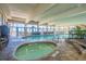 Bright indoor pool area featuring a jacuzzi, ample seating, and large windows with ocean views at 2301 S Ocean Blvd. # 825, Myrtle Beach, SC 29577