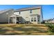 Back of house featuring screened-in porch, well-maintained lawn and a patio, perfect for outdoor gatherings at 2449 Campton Loop, Conway, SC 29527