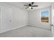 A bright, carpeted bedroom with a ceiling fan and ample natural light at 2449 Campton Loop, Conway, SC 29527