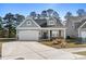 Charming one-story home featuring a two-car garage and a welcoming front porch at 2449 Campton Loop, Conway, SC 29527
