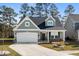 Charming one-story home featuring a two-car garage and a welcoming front porch at 2449 Campton Loop, Conway, SC 29527