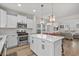 Updated kitchen with stainless steel appliances, white cabinetry, quartz countertops and an island with barstool seating at 2449 Campton Loop, Conway, SC 29527
