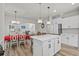 Open kitchen with stainless steel appliances, white cabinets, quartz countertops and an island with seating at 2449 Campton Loop, Conway, SC 29527