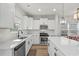 Modern kitchen with stainless steel appliances, white cabinetry and countertops, and modern light fixtures at 2449 Campton Loop, Conway, SC 29527