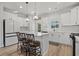 Bright kitchen featuring stainless steel appliances, white cabinets, an island, and a door to the outdoor patio at 2449 Campton Loop, Conway, SC 29527