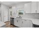 Bright kitchen with stainless steel appliances, white cabinetry and countertops, and backyard access at 2449 Campton Loop, Conway, SC 29527