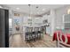 Modern kitchen with stainless steel appliances, white cabinetry, and a large island with barstool seating at 2449 Campton Loop, Conway, SC 29527