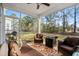 Cozy screened patio with comfortable seating, a ceiling fan, and views of the lush backyard at 2449 Campton Loop, Conway, SC 29527