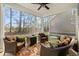 Relaxing screened-in patio with comfortable seating, outdoor rug, and ceiling fan, perfect for enjoying the outdoors at 2449 Campton Loop, Conway, SC 29527
