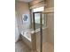 Bright bathroom featuring a soaking tub, a separate shower, and a window with privacy blinds at 2501 Brescia St., Myrtle Beach, SC 29579