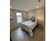 Comfortable bedroom with a large window, stylish decor, and wood flooring at 2501 Brescia St., Myrtle Beach, SC 29579