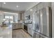 Modern kitchen featuring stainless steel appliances, gray cabinets, quartz countertops, and wood flooring at 2501 Brescia St., Myrtle Beach, SC 29579