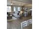 Bright, open-concept living area featuring a large sectional sofa, hardwood floors, and modern kitchen with stainless steel appliances at 2501 Brescia St., Myrtle Beach, SC 29579
