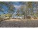 This backyard features mature trees, a detached area, and an outdoor area with an outdoor grill at 2505 Redwood St., Georgetown, SC 29440
