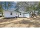 The backyard features a green roof, white siding, mature trees, and outdoor space at 2505 Redwood St., Georgetown, SC 29440
