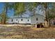 This backyard features mature trees, green roof, an outdoor brick grill, and white siding at 2505 Redwood St., Georgetown, SC 29440