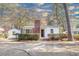 Quaint home showcasing a classic brick chimney, green metal roof, and welcoming entrance at 2505 Redwood St., Georgetown, SC 29440