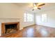 Inviting living room featuring hardwood floors, a ceiling fan, and a traditional brick fireplace at 2505 Redwood St., Georgetown, SC 29440