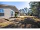 Spacious backyard featuring a charming fire pit, screened porch, and well-maintained landscaping at 260 Barclay Dr., Myrtle Beach, SC 29579
