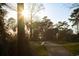 Picturesque view of the golf course path surrounded by trees, bathed in sunlight, and a serene landscape at 260 Barclay Dr., Myrtle Beach, SC 29579