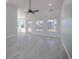 Bright living room featuring gray floors, large windows, and a ceiling fan at 260 Barclay Dr., Myrtle Beach, SC 29579