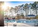 Inviting community pool surrounded by lush trees, offering a serene atmosphere at 260 Barclay Dr., Myrtle Beach, SC 29579