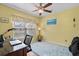 This bedroom has a ceiling fan and a desk facing the large window at 2621 Corn Pile Rd., Myrtle Beach, SC 29588