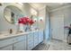 Double sink bathroom vanity with marble countertops, gold fixtures, framed mirrors, and decorative flowers at 2803 Ships Wheel Dr., North Myrtle Beach, SC 29582