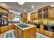 Traditional kitchen featuring a large center island cooktop, custom wood cabinets, and wine storage at 2803 Ships Wheel Dr., North Myrtle Beach, SC 29582