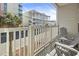 Condo balcony with seating overlooks the street and views of the nearby condo building at 3401 N Ocean Blvd. # 109, North Myrtle Beach, SC 29582