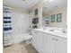 Bright bathroom featuring double sinks, vanity, a large mirror and tub with shower at 3401 N Ocean Blvd. # 109, North Myrtle Beach, SC 29582
