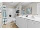 Bathroom with double sink vanity, shower, and coastal-themed decor at 3401 N Ocean Blvd. # 109, North Myrtle Beach, SC 29582
