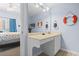 Bathroom features a vanity with nautical decor, a large mirror, and access to the bedroom at 3401 N Ocean Blvd. # 109, North Myrtle Beach, SC 29582