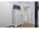 Bedroom featuring white dresser with television and access to the home's common areas at 3401 N Ocean Blvd. # 109, North Myrtle Beach, SC 29582